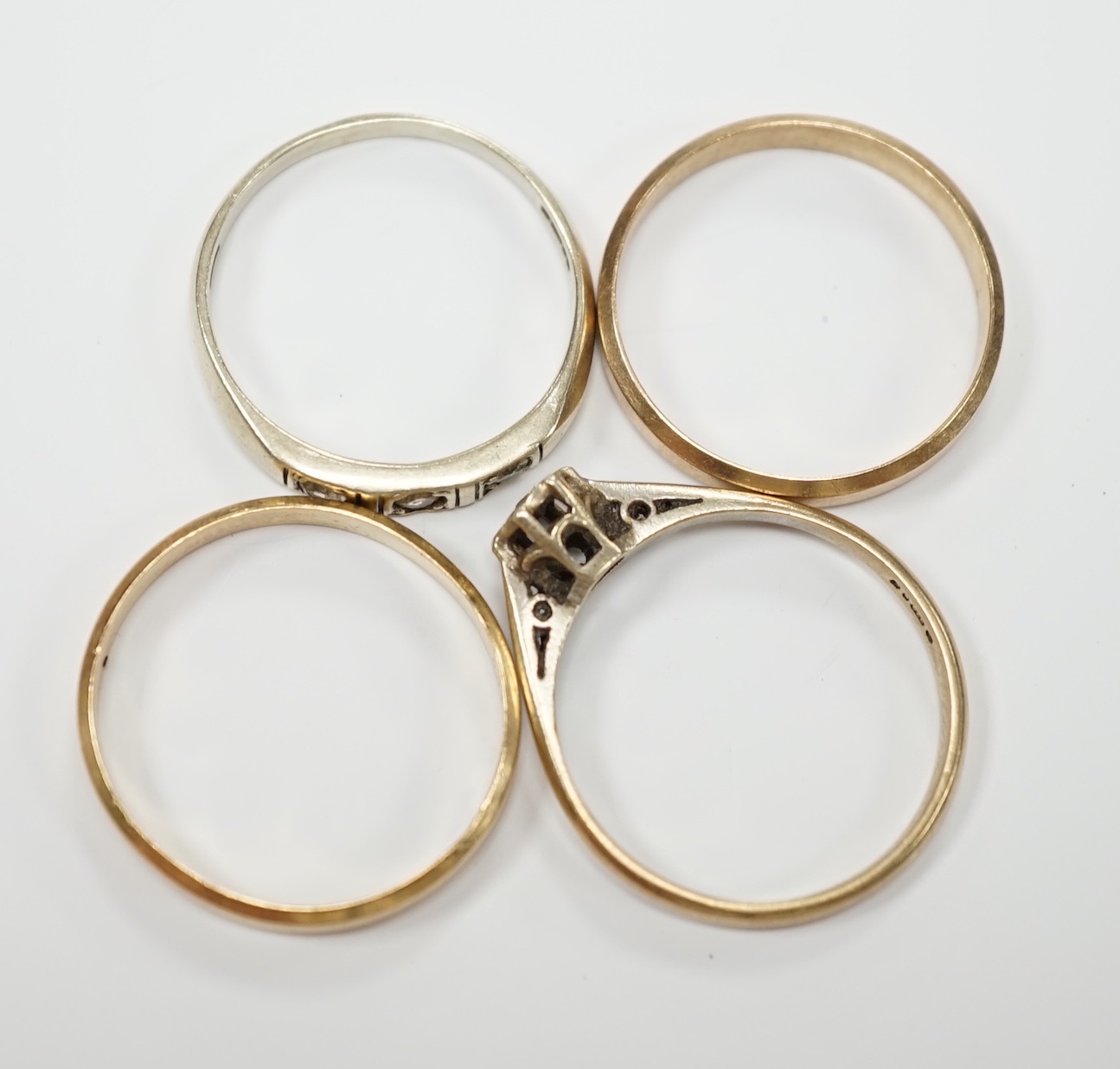 Two 585 yellow metal wedding bands, 4.1 grams and two 9ct gold and gem set rings, gross weight 4.2 grams.